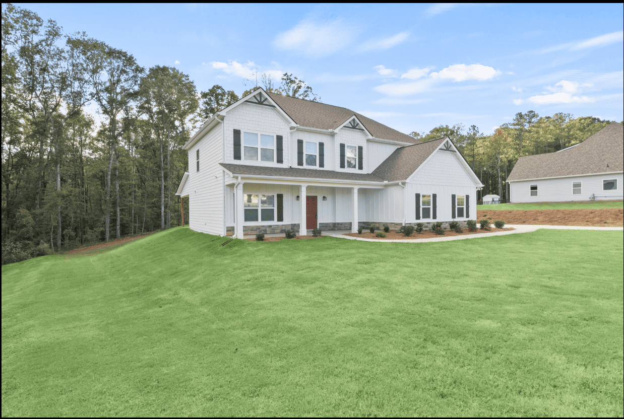 White two-story house on green lawn.
