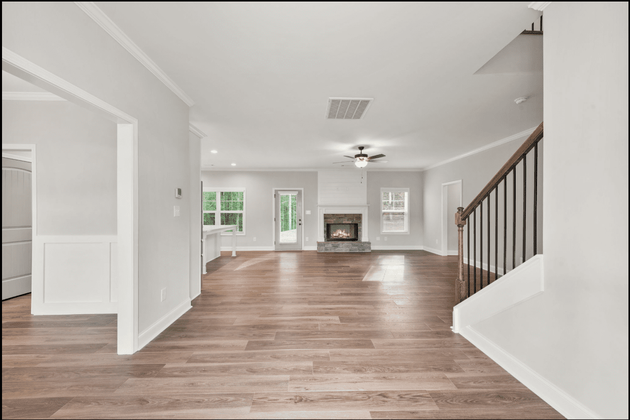 Spacious living room with fireplace and hardwood floors.