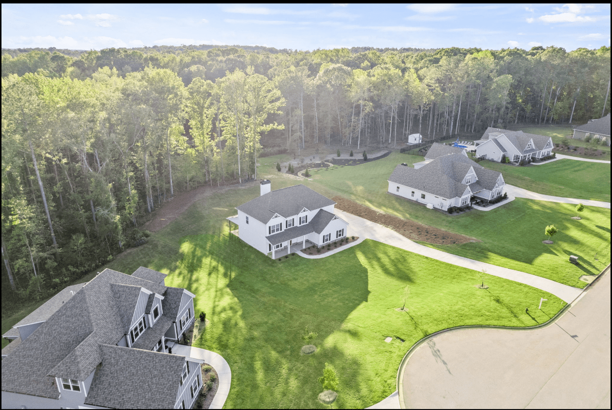 Aerial view of new homes in wooded area.