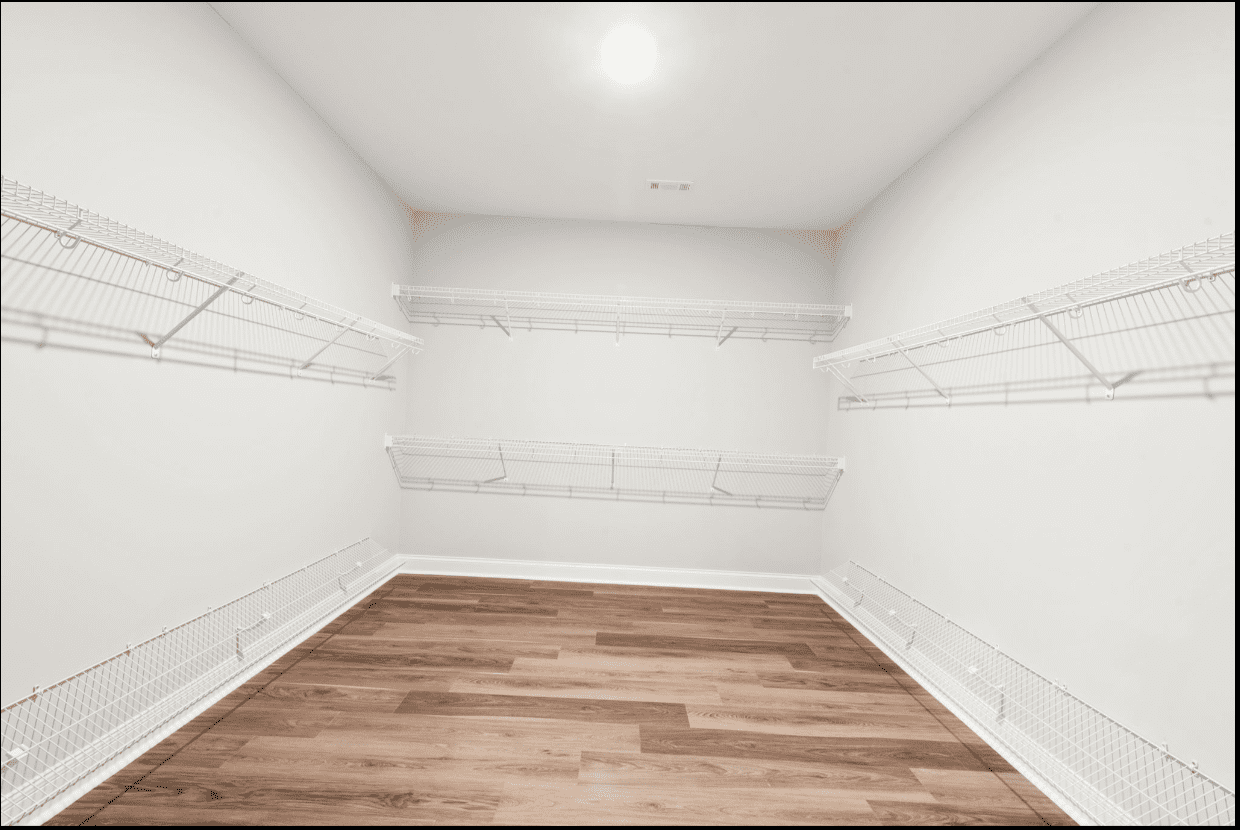 Empty walk-in closet with wire shelving.