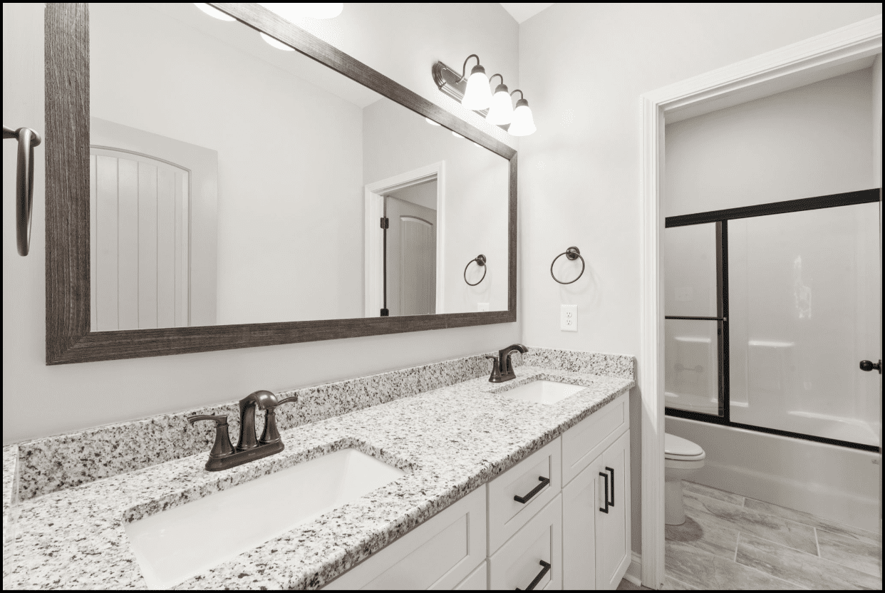 Granite double vanity with large mirror.