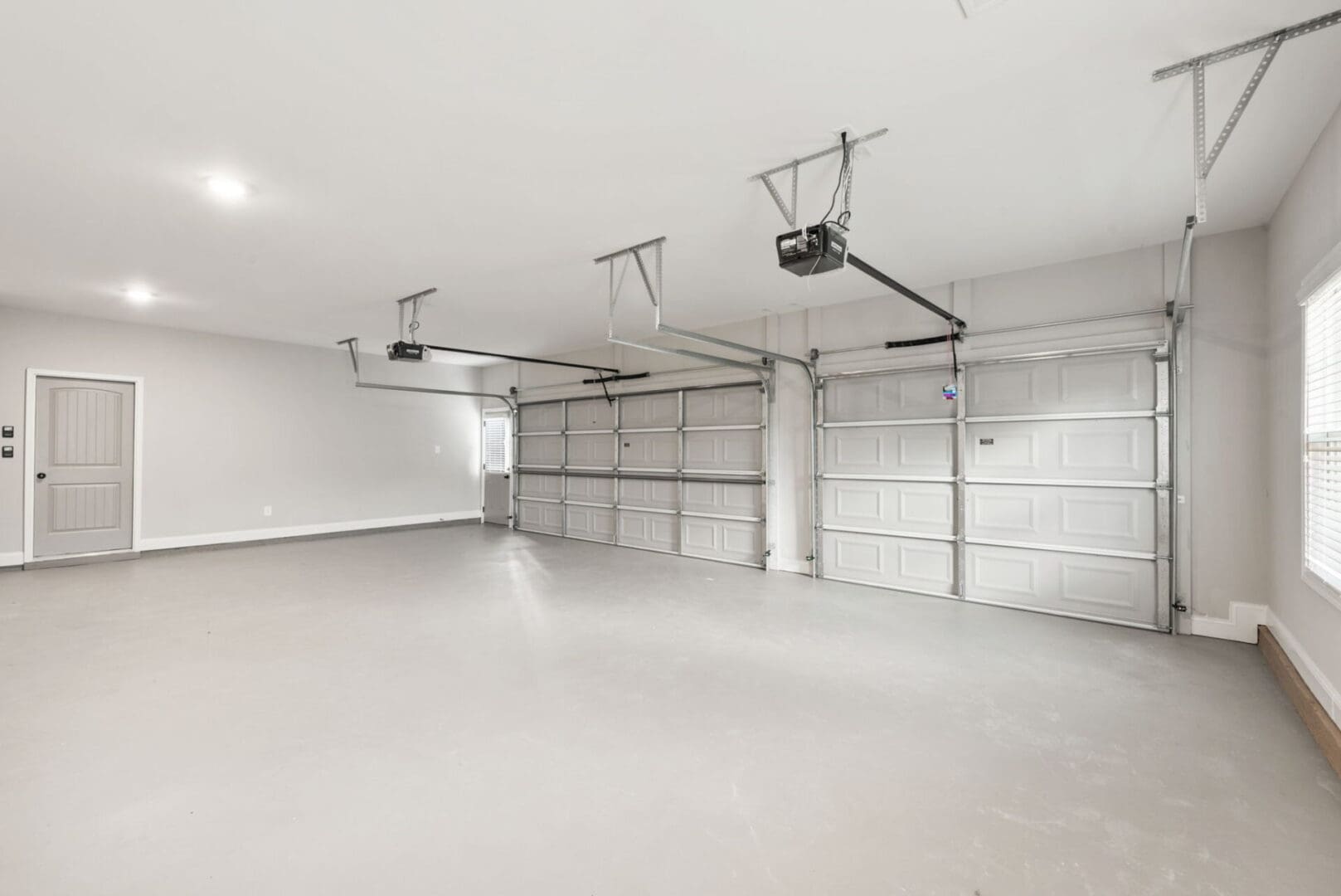 Empty spacious garage with two doors.