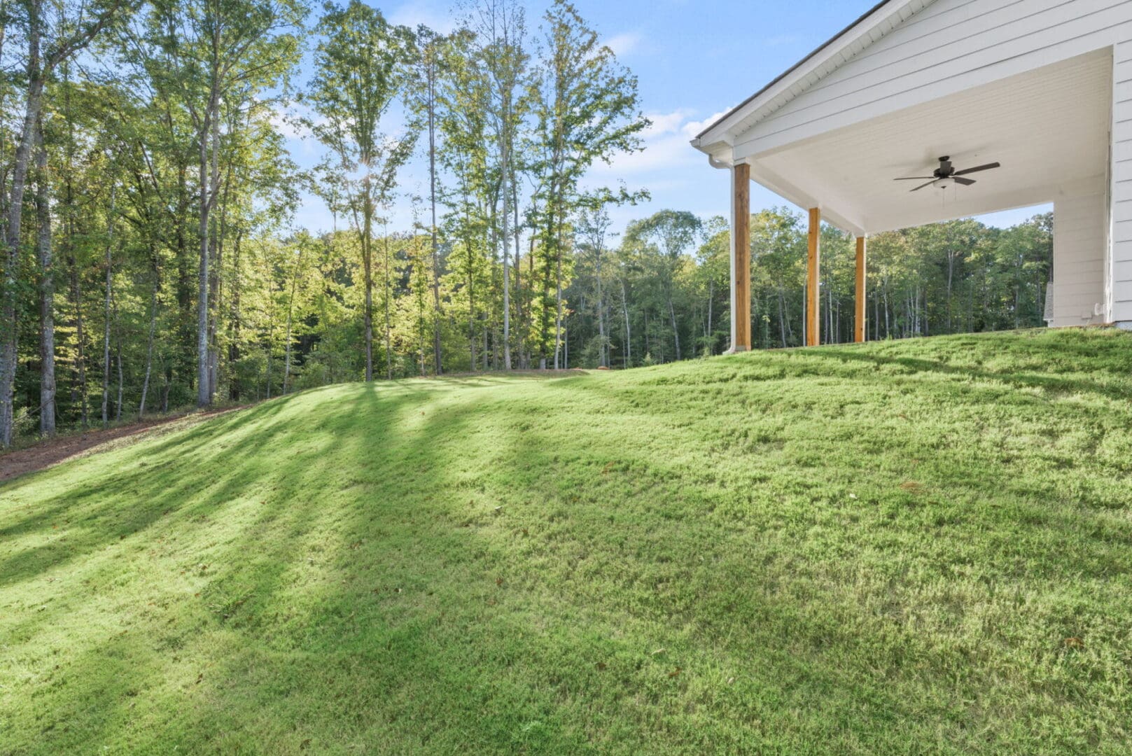 House porch overlooking grassy hillside.