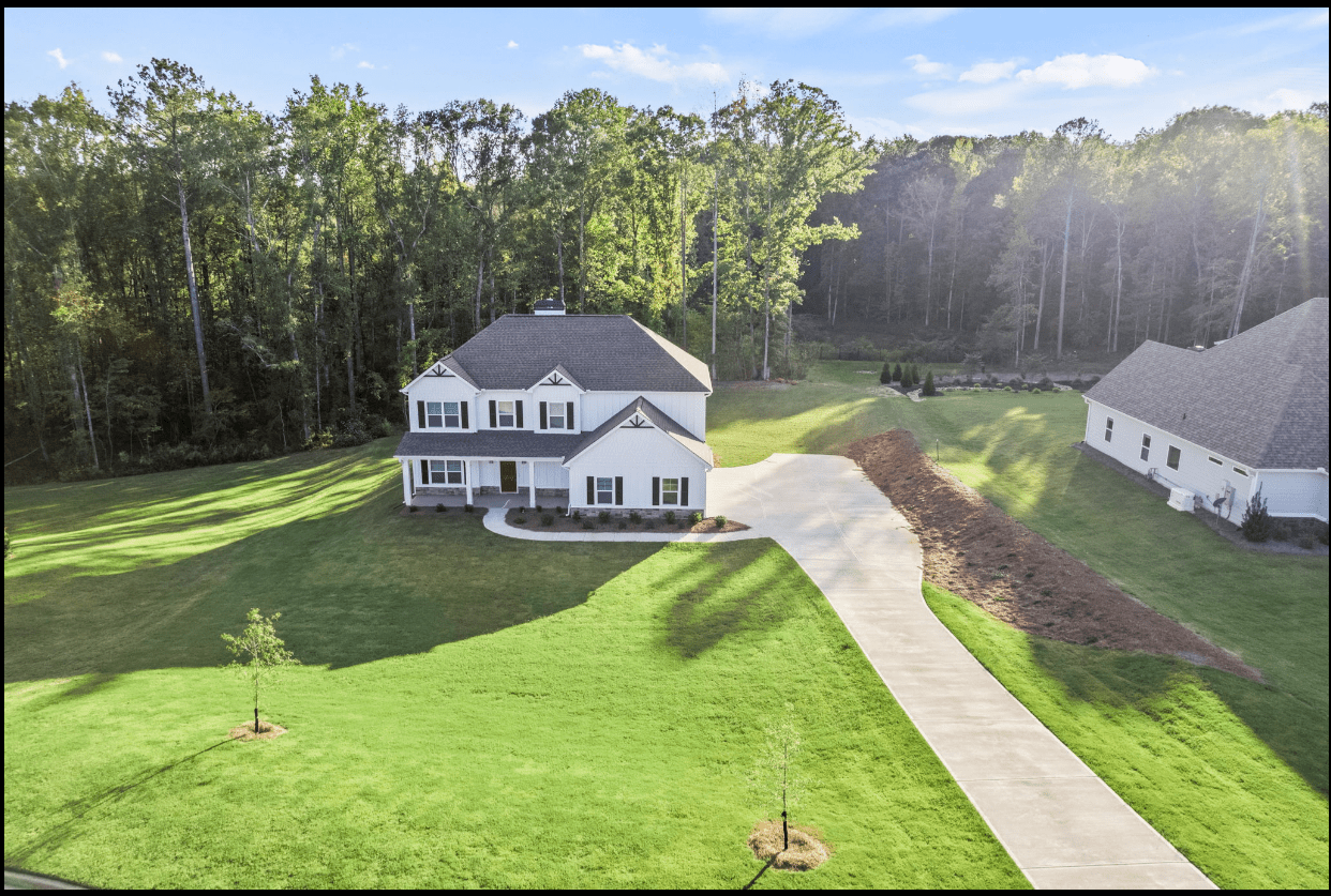 Aerial view of a white house and yard.