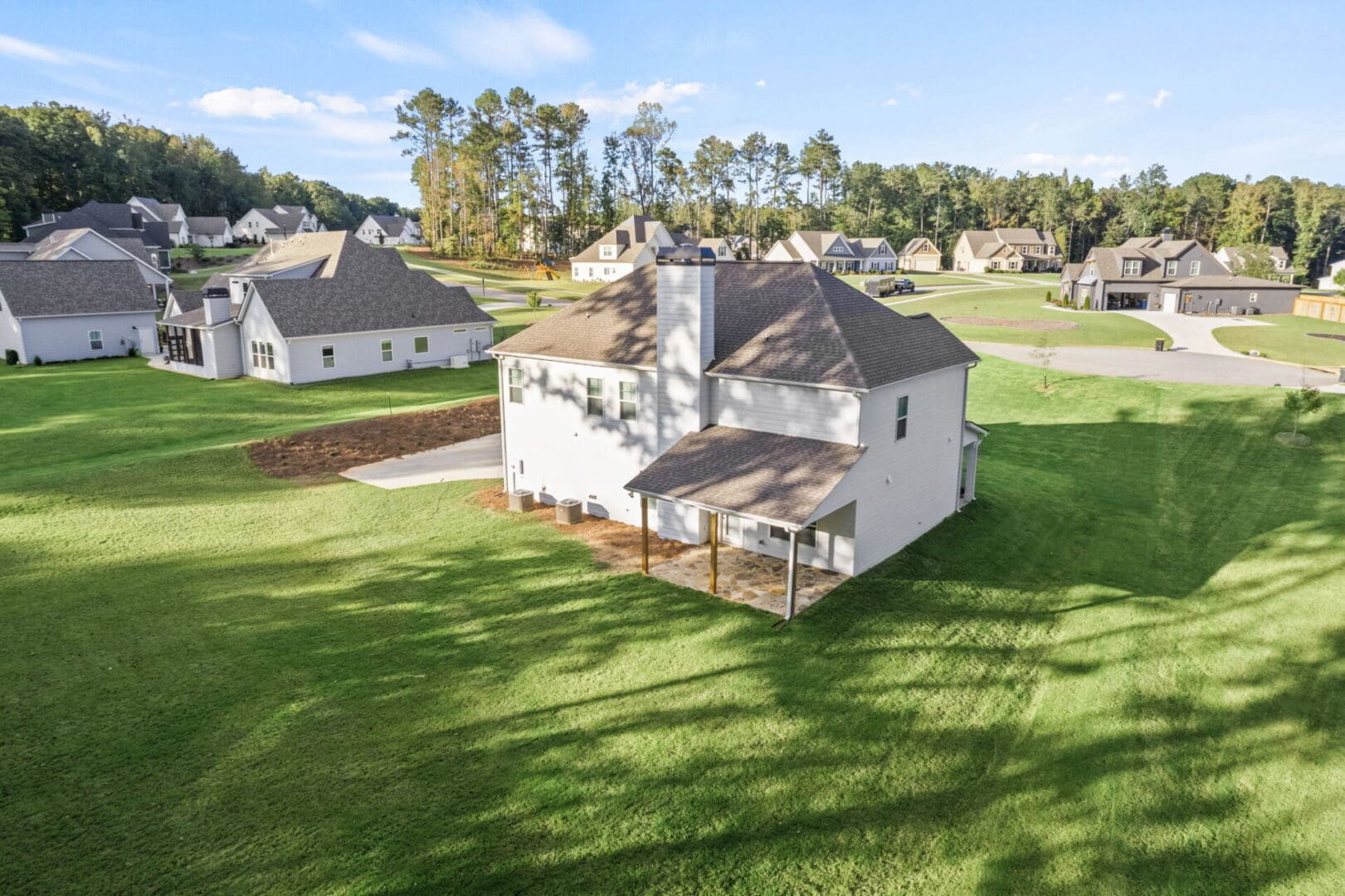 Aerial view of a house and backyard.