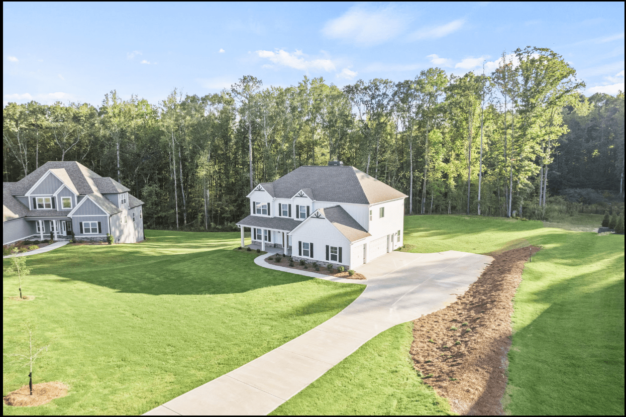 Aerial view of two-story house and driveway.
