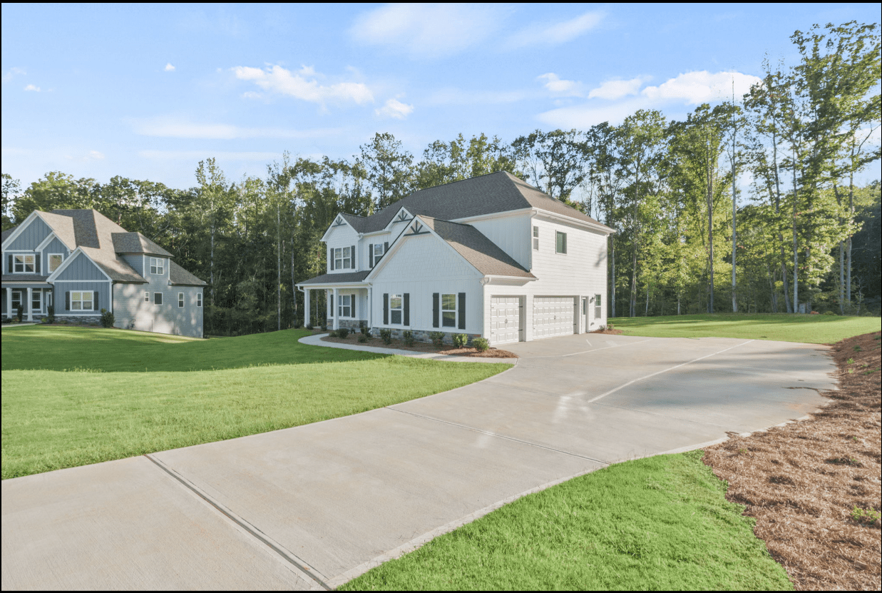 White house with three-car garage.